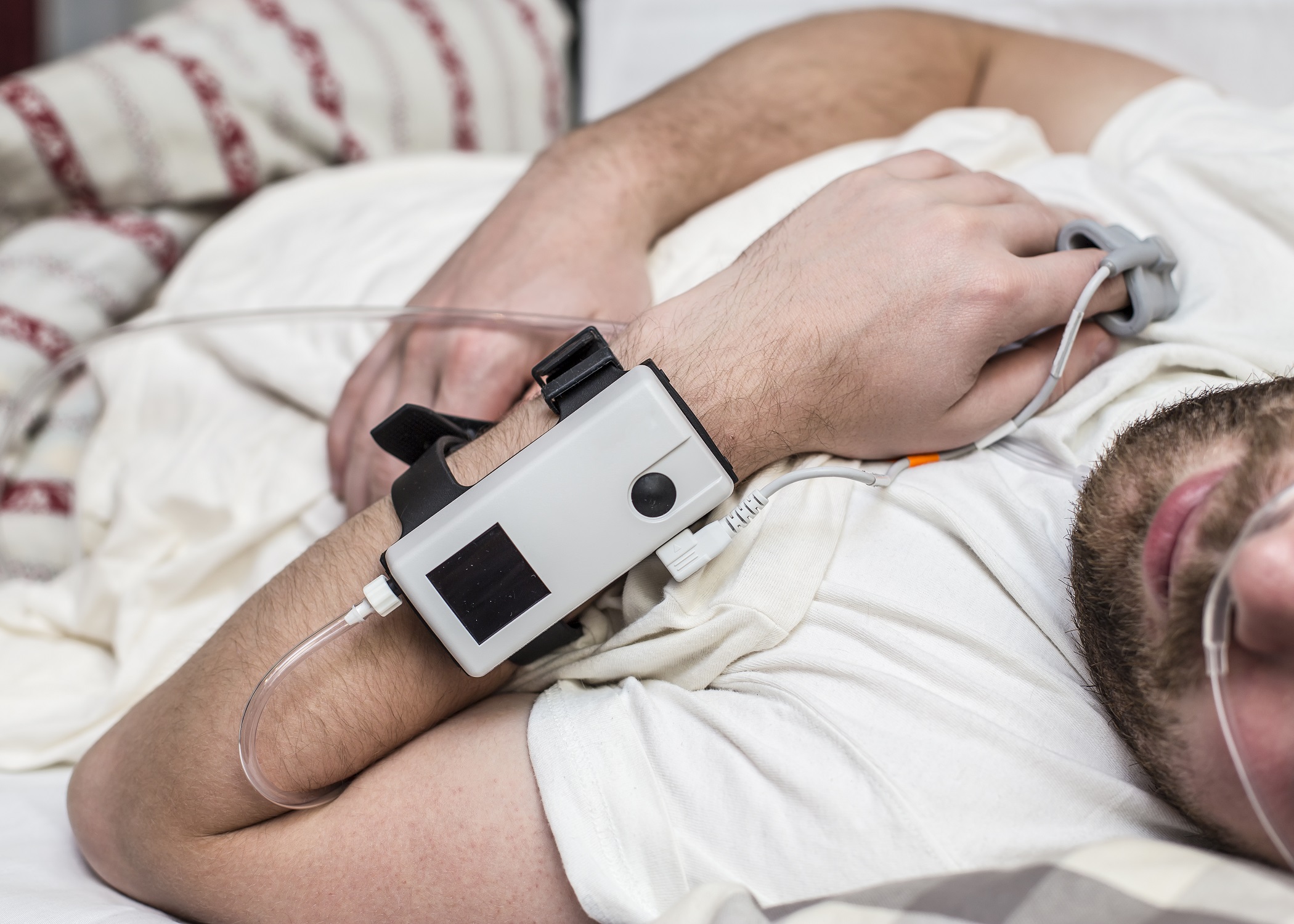 Sleep Apnea Diagnostic medical device Kit attached to the finger and the human nose, which lies in bed